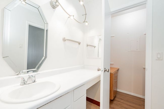 Bathroom featuring baseboards, wood finished floors, and vanity | Image 22