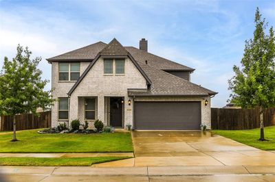 View of front of property featuring a garage and a front yard | Image 1