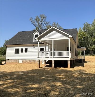 Back of property featuring central air condition unit and a lawn | Image 3