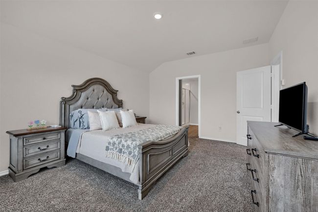 Bedroom featuring dark colored carpet and recessed lighting | Image 18