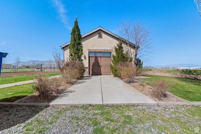 View of front of property featuring a front yard, a mountain view, and stucco siding | Image 11