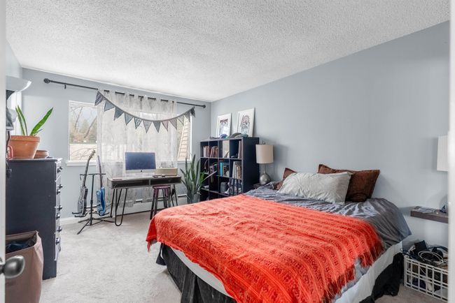 Bedroom featuring carpet flooring and a textured ceiling | Image 10