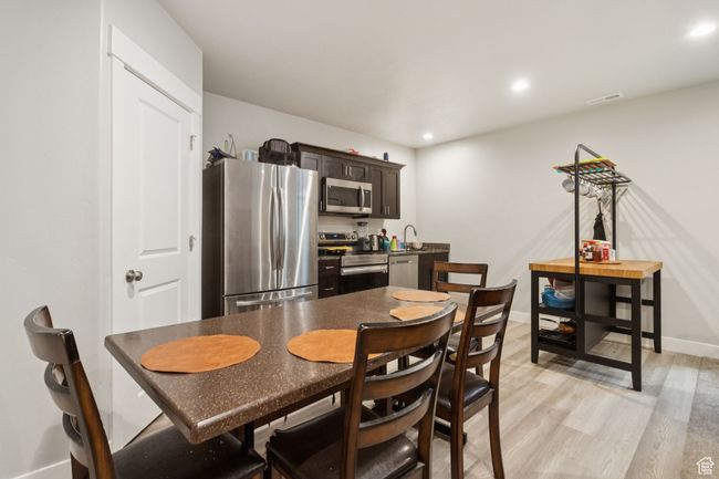 Dining room with light wood-type flooring and recessed lighting | Image 33