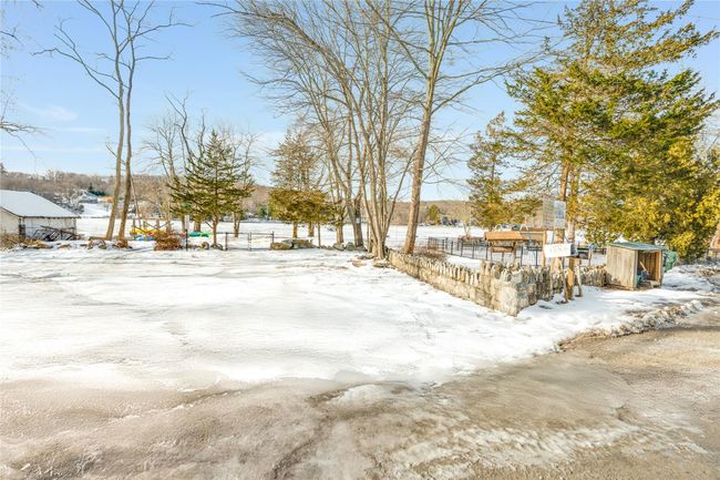 Yard covered in snow featuring fence | Image 21