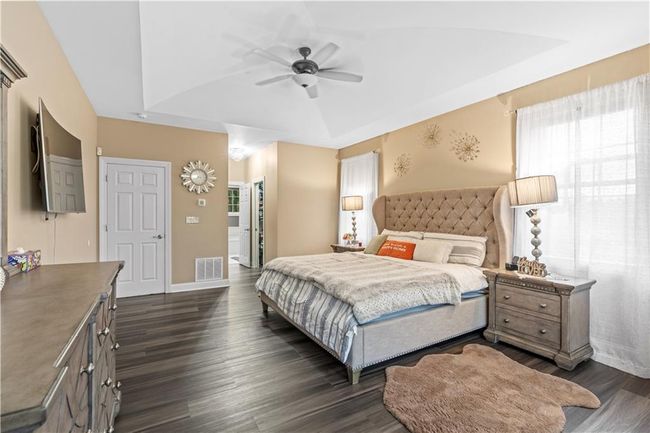 Bedroom featuring dark wood-type flooring, baseboards, and ceiling fan | Image 19
