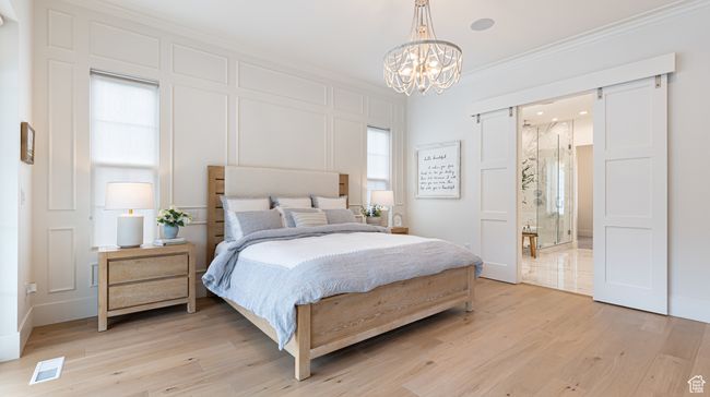 Bedroom with light wood-type flooring, visible vents, a notable chandelier, and ornamental molding | Image 13