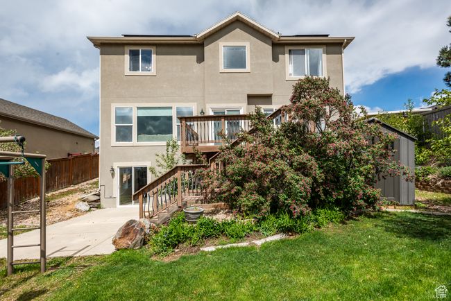 Rear view of house with stucco siding, a patio, stairway, and a deck | Image 35