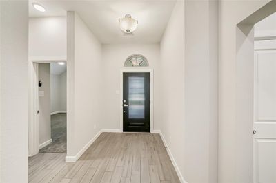 Stepping through the entry of the home you are greeted with tile flooring that is carried throughout the house. | Image 3