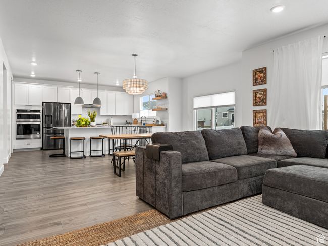 Living area featuring light wood-type flooring and recessed lighting | Image 15