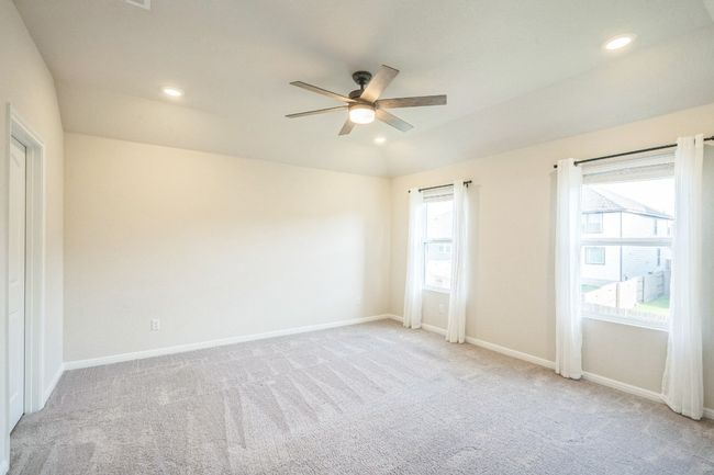 Carpeted spare room with a ceiling fan, baseboards, lofted ceiling, and recessed lighting | Image 12