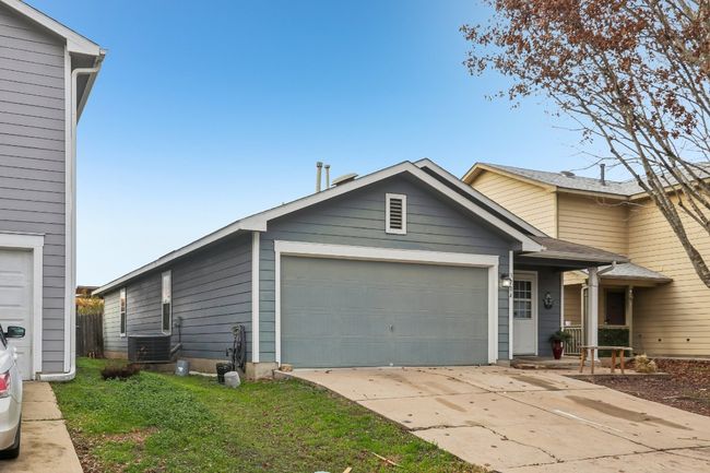 View of front of house featuring a garage, cooling unit, and driveway | Image 4