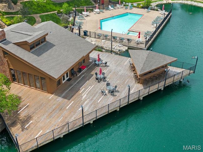View of subject property featuring a pool area and a large body of water | Image 32