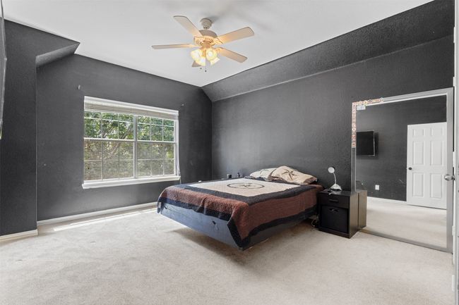 Carpeted bedroom with ceiling fan, lofted ceiling, and baseboards | Image 31
