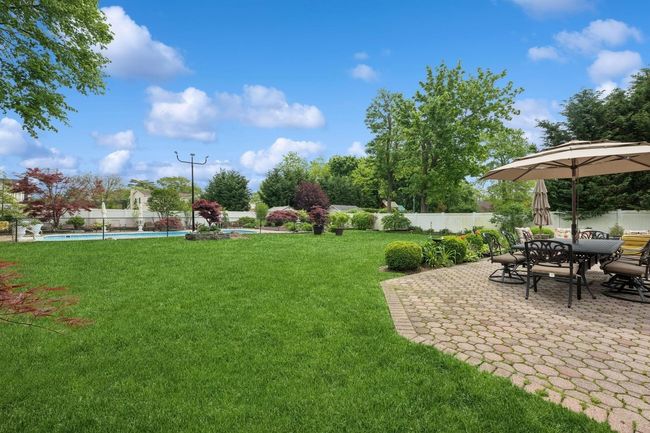 View of yard with a patio and outdoor dining area | Image 28