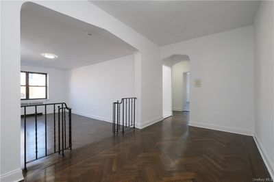 APT. 65 - Gallery/Dning Foyer looking east w/ view of sunken Living Room facing north to left of photo. NOTE: Hall to EIK, Bath & Bedrooms in center of photo. | Image 1