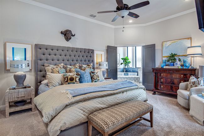 Bedroom featuring visible vents, ceiling fan, crown molding, a towering ceiling, and carpet flooring | Image 32