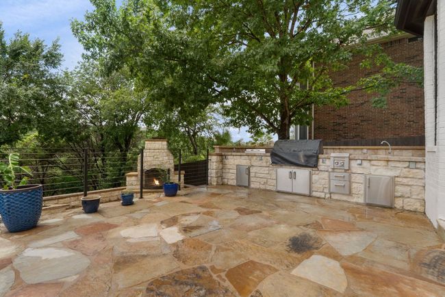 The expansive patio offers a seamless extension of indoor living, perfect for relaxing in the shade or entertaining year-round. | Image 29