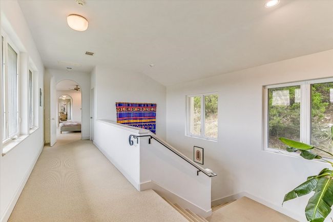 Corridor with an upstairs landing, lofted ceiling, light colored carpet, and recessed lighting | Image 20