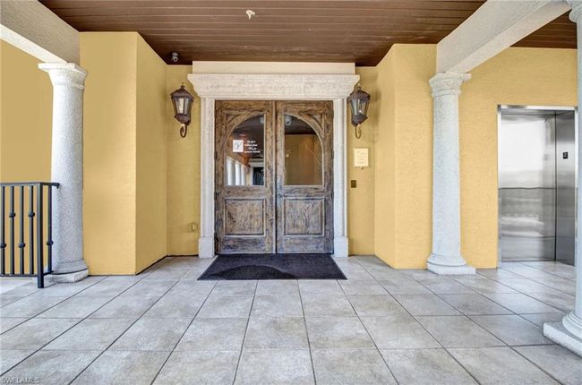 Entrance to property with stucco siding and elevator | Image 41