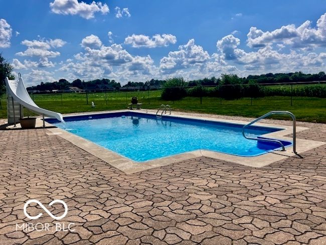 view of pool featuring a water slide and a patio area | Image 66