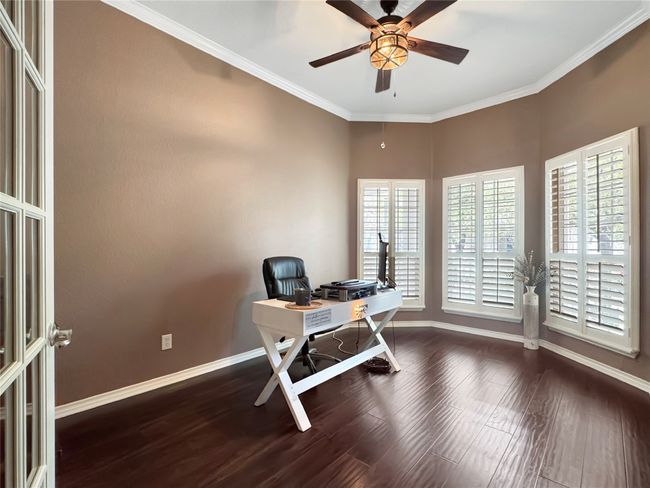 Large office at the front of the house with natural light that looks over the front patio | Image 10