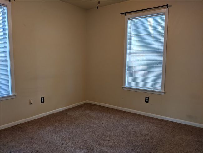 Carpeted empty room with healthy amount of natural light | Image 8
