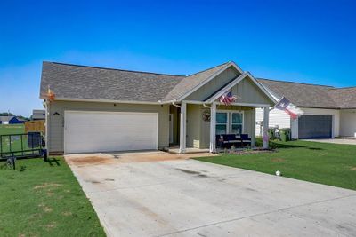 Single story home featuring a garage and a front yard | Image 3