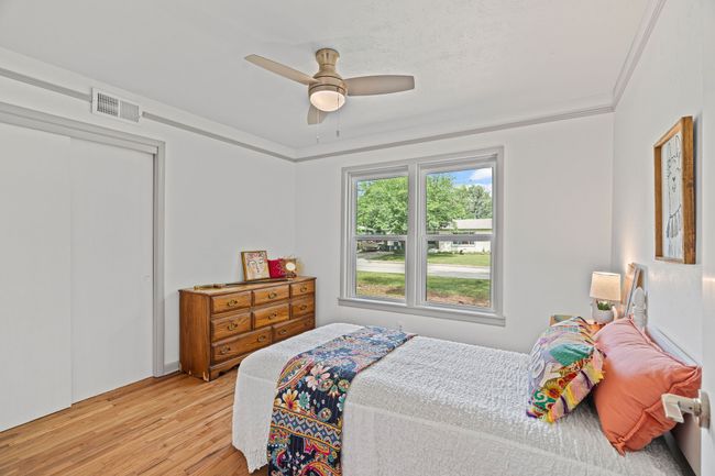 Bedroom with light wood finished floors, a ceiling fan, and a closet | Image 26