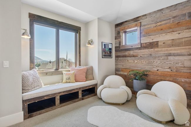 Sitting room featuring wooden walls and carpet | Image 56