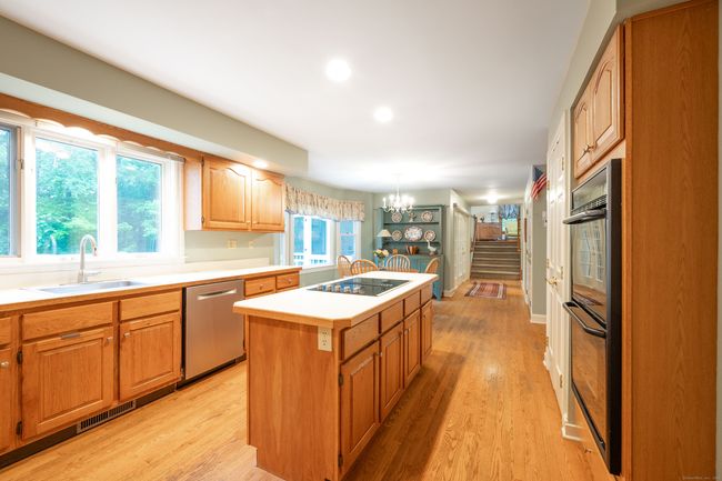 Eat-in Kitchen featuring cooktop, double ovens and view through to 3/4 story family room | Image 13