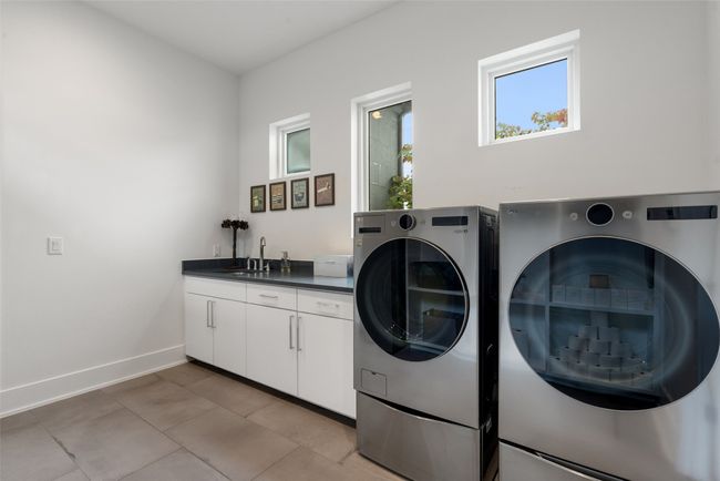 A bright, functional laundry space with modern efficiency. | Image 25