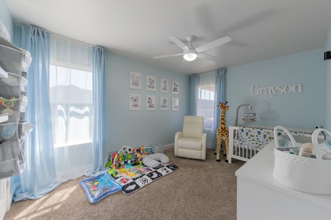 Bedroom with multiple windows, carpet, and a ceiling fan | Image 26
