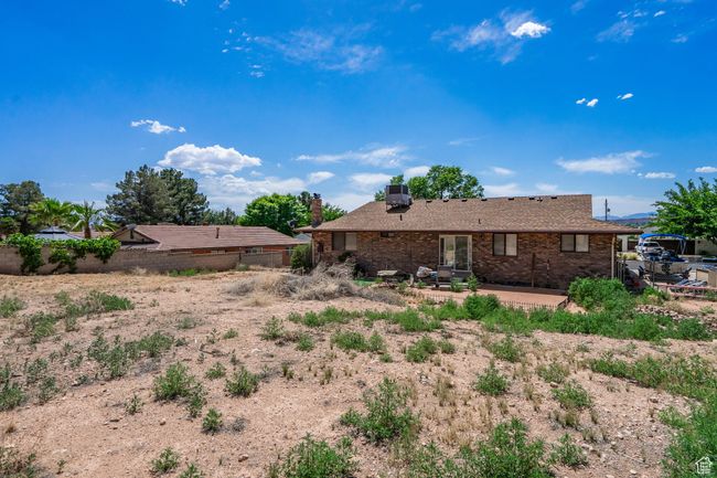 Rear view of property featuring a patio area and brick siding | Image 54