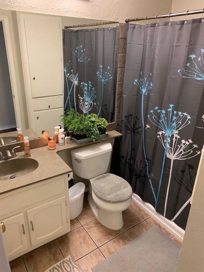 Bathroom featuring vanity, toilet, tile patterned flooring, and a shower with curtain | Image 11