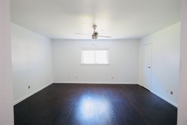 Master Bedroom with dark wood-style floors and ceiling fan | Image 29