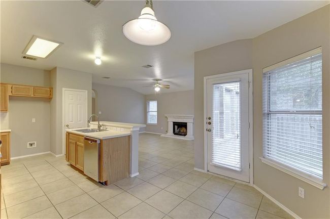 Empty room featuring lofted ceiling, light tile patterned floors, and a textured ceiling | Image 8