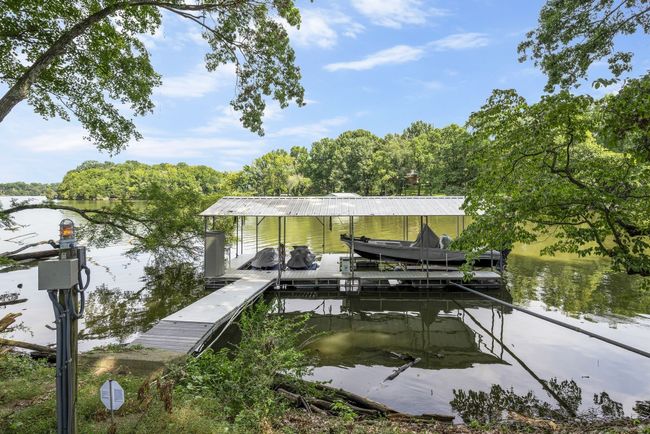 This peaceful cove is sheltered by the Corps of Engineers land to the west of the home that blocks wake and wind and keeps your dock secure from the elements! | Image 53