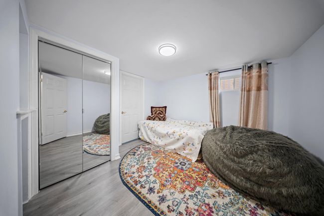 Bedroom featuring wood finished floors and a closet | Image 19