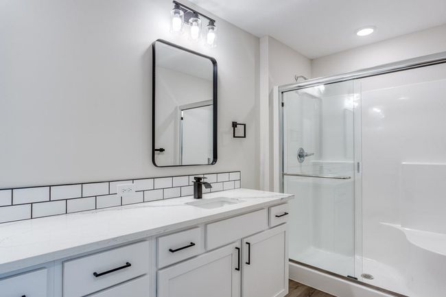 Full bath with a shower stall, vanity, and tasteful backsplash | Image 22