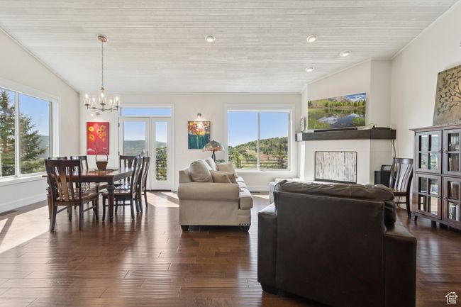 Living area featuring a chandelier, wood ceiling, and dark wood-style flooring | Image 11