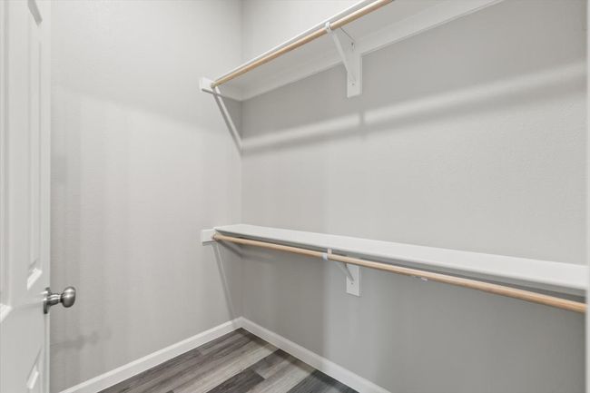 Spacious closet with dark hardwood / wood-style floors | Image 17