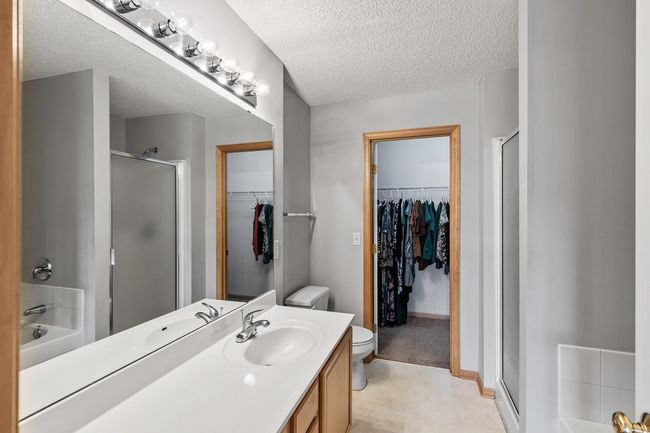 Upper level private primary bath with walk-in shower, separate soaking tub and a walk-in closet | Image 10