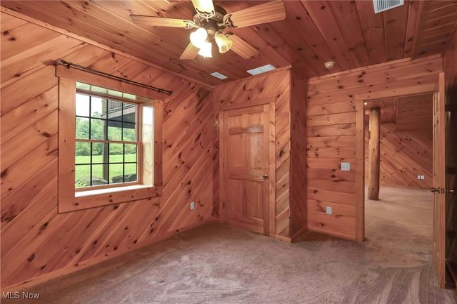 Lower level bedroom view toward closet and exit | Image 36