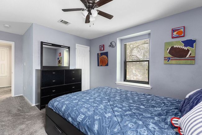 Bedroom with carpet, baseboards, and ceiling fan | Image 29