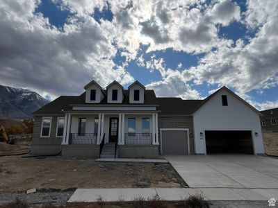 View of front facade with a mountain view, a garage, and covered porch | Image 2