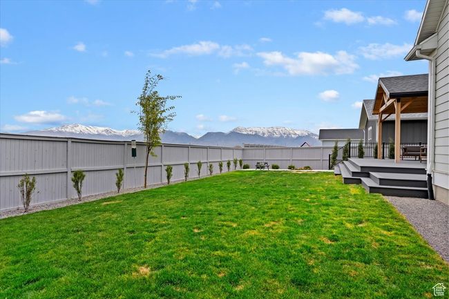 View of yard featuring a fenced backyard and a deck with mountain view | Image 37