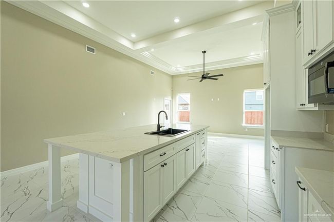Kitchen featuring baseboards, visible vents, marble finish floor, a sink, and recessed lighting | Image 15