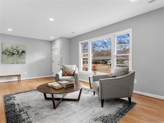 Living area featuring light wood-style floors, visible vents, baseboards, and recessed lighting | Image 36