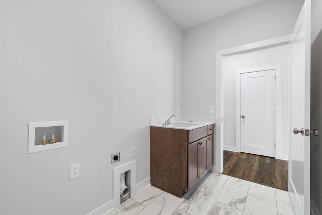 Conveniently located right off of the master walk-in closet, this laundry room offers easy access to the bedroom and main living space, making laundry day a breeze. | Image 27