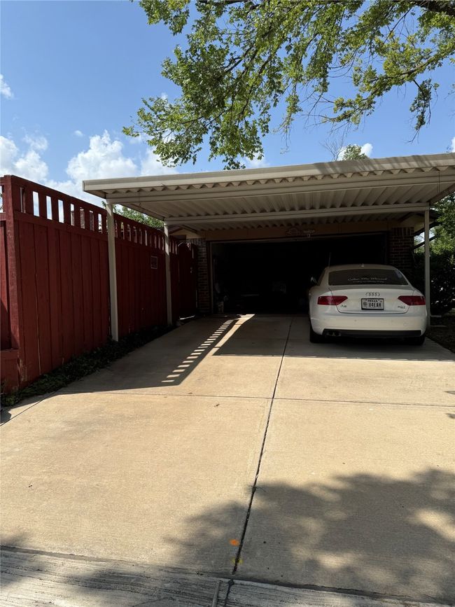 Rear garage with metal carport. | Image 4